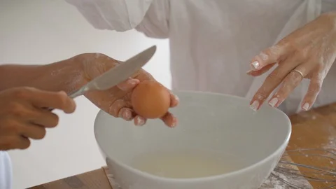 Close-up view of the hands of young female loving couple cook pancakes or Stock Footage 129609383