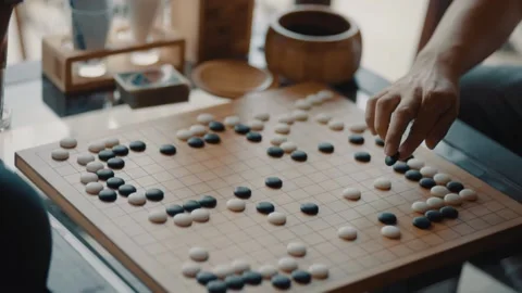 Close up view of hands young people playing go board game in living room Stock Footage 131551024