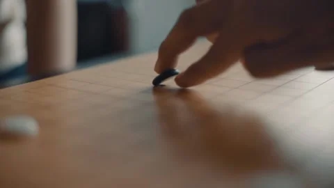 Close up view of hands young people playing go board game in living room Stock Footage 134273686