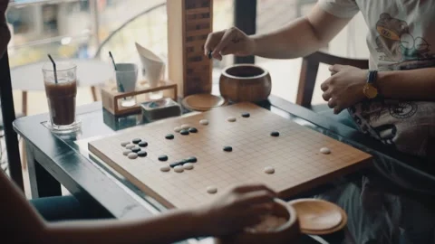 Close up view of hands young people playing go board game in living room Stock Footage 134273697