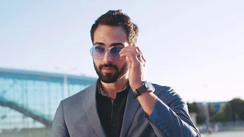 Close up view of a handsome bearded man in a suit looking right towards the Stock Footage 76748350