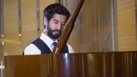 Close up view of handsome bearded pianist playing the fortepiano enjoying the Stock Footage 105075335