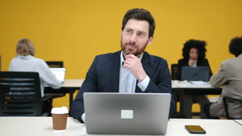 Close-up view of a handsome man working on his laptop in modern office space Stock Footage 237217398