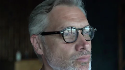 A close-up view of a handsome mature man thinking while standing in the office. Stock Footage 136534434