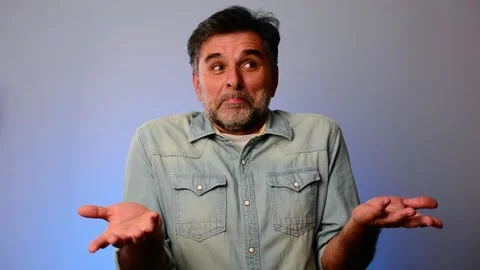 Close up view of handsome mature man looks confused and shrugs his shoulders Stock-Footage 148289635