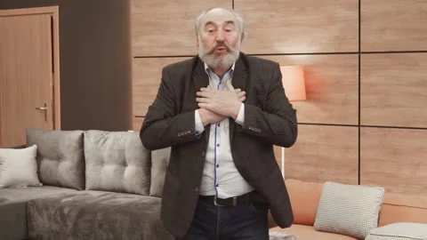 Close up view of handsome Old bearded man shruggs his shoulders. Uncomfortable,  Video stock 148951860