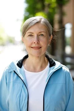 Close View of the Handsome Positive Smiled Mature Woman Looking at the Camera Stock Photos