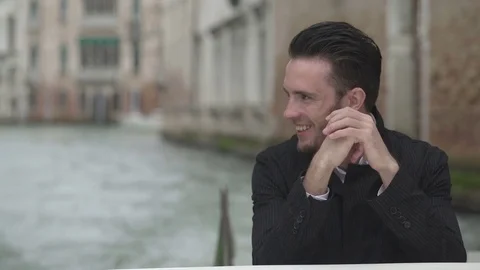 The close-up view of the handsome smiling man waving hi and enjoying the Stock Footage 82615476
