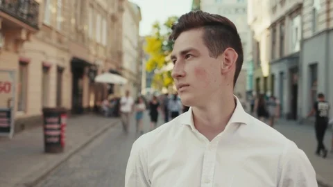 Close up view of handsome young man looking straight to camera while standing at Stock Footage 91993670