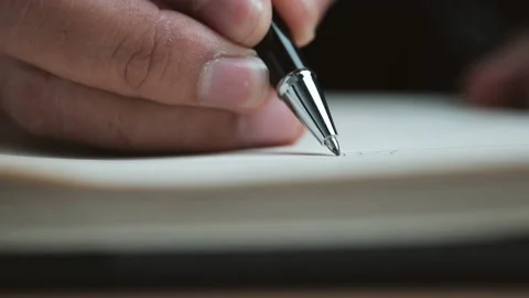 Close up view of a handwriting down on a white blank notebook Stock Footage 151615308