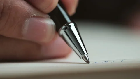 Close-up view of a handwriting down on a white blank notebook Stock-Footage 151727640