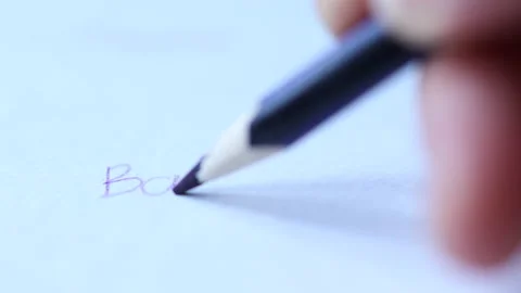Close-up view of handwriting word back to with dark blue pencil Video stock 157995957