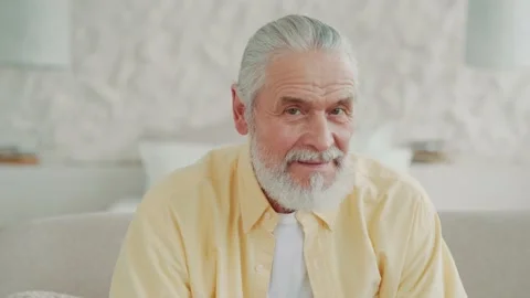 Close up view happy face of older senior adult man looking at the camera sitting Vídeos de archivo 224537876