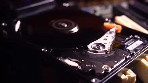 Close-up view of a hard drive's reading arm interacting with spinning disk Stock Footage 306540294