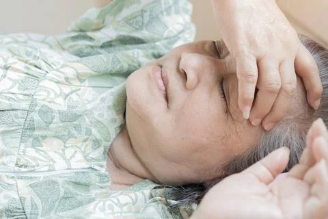 Close-up view head shot close up older woman lying in bed at home, covering.. Stock Photos