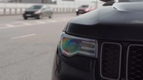 Close-up view of the headlight and blinking emergency sign of black car suv 스톡 동영상 220526072