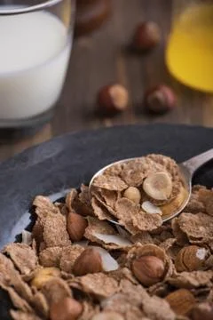Close up view of healthy breakfast with nuts and corn flakes on brown rustic  Stock Photos
