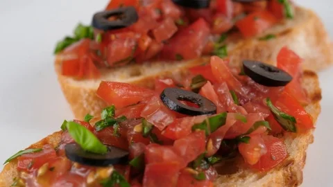 Close-up view of healthy snacks, fresh toasted bread with chopped tomatoes Stock Footage 79926016