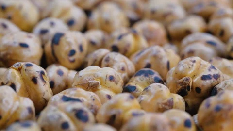 Close-up view. Heap of roasted fresh chickpeas, Turkish nut Leblebi Stock Footage 296556796
