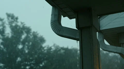 Close up view of Heavy rain water flowing from a roof drain during storm Stock Footage 341542085