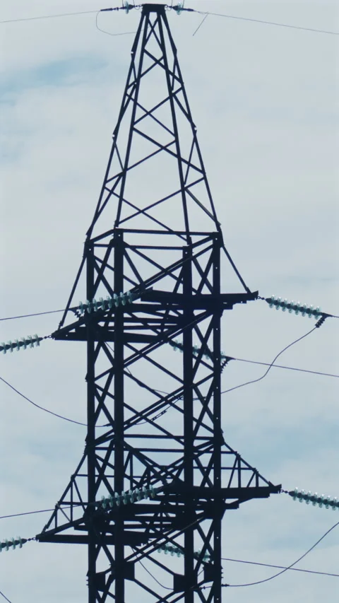 Close up view of a high voltage electricity transmission tower and power lines Stock Footage 336869889