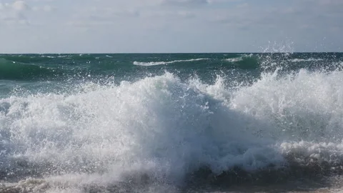 Close up view on high waves with foam and splashes on the empty coast of the Video stock 216676311