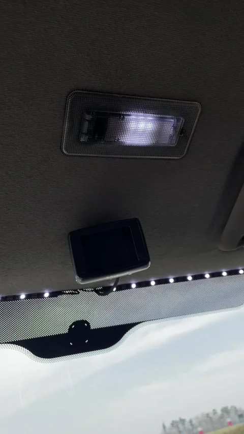 Close view highlighting car ceiling lamp and interior specifics during daytime Stockbeeldmateriaal 347332378