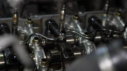 A close-up view highlights fuel rail tubes and fuel injectors installed on th Stock Footage 345108523