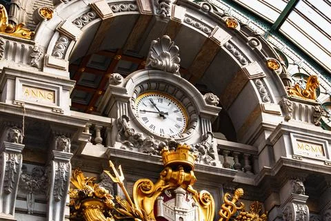 Close View of Historic Station Clock and Gilded Antwerp Coat of Arms in Belgi Stock Photos