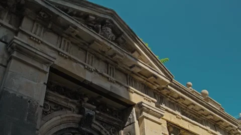 Close-Up View of Historic Stone Building Facade Against Blue Sky Stock Footage 338243626