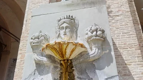 Close view of a historic stone wall fountain in Parma, Italy, with a carved Stock Footage 345520715