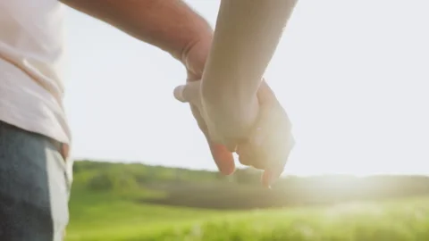 Close-up view of holding hands of a couple in the countryside on romantic date Stock Footage 248174004