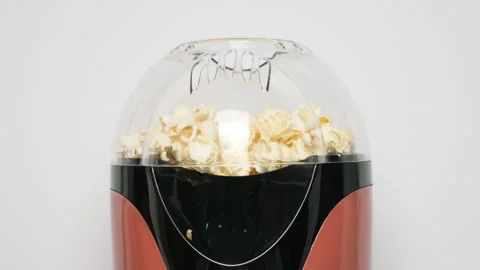 Close up view on home popcorn maker making fresh crispy popcorn. Popcorn popper Stock Footage 276901627
