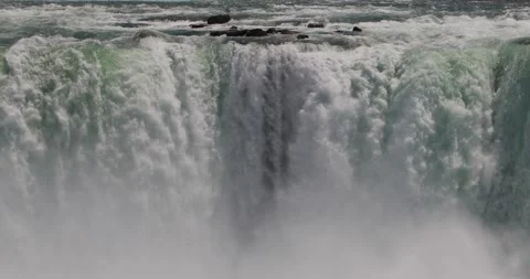 Close view of Horseshoe Falls water roaring over the brink into mist. Video stock 320026567