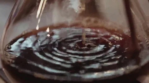 Close up view of hot, fresh coffee flow into the pot Stock Footage 69083644