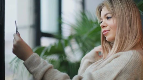 Close up view of hot smiling attractive young blonde woman correcting her Stock Footage 104563262