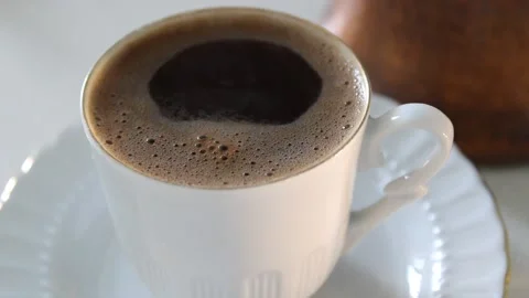 Close up view of hot steaming coffee in the cup and cooking pot Stock Footage 150731003