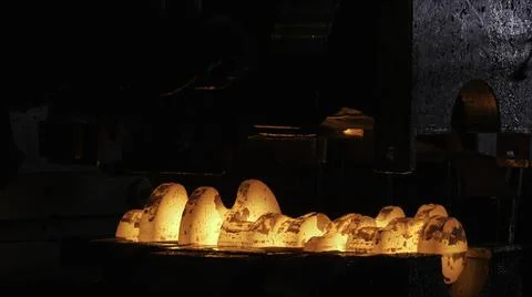 Close up view of hot steel forging process with big mechanical hammer machine Stock Photos