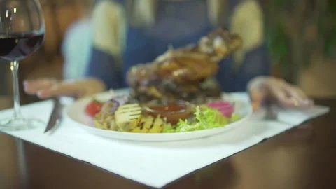 Close up view on huge fried grilled piece of meat on vegetable plate woman hands Stock Footage 137537456