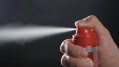 Close-up view of human hand and spray bottle isolated on black parfume Stock Footage 87305105