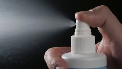 Close-up view of human hand and spray bottle isolated on black parfume Stock Footage 87305113