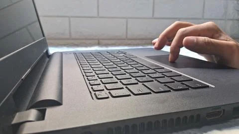Close up view of human hand using black laptop keyboard Stock Photos