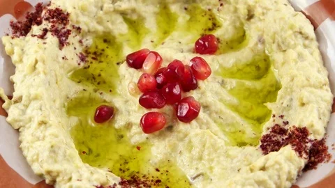 Close-up view of Hummus, decorated with garnet fruit seeds Stock Footage 75672934