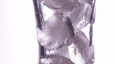 Close up view of the ice cubes in rotating glass Stock Footage 34311305