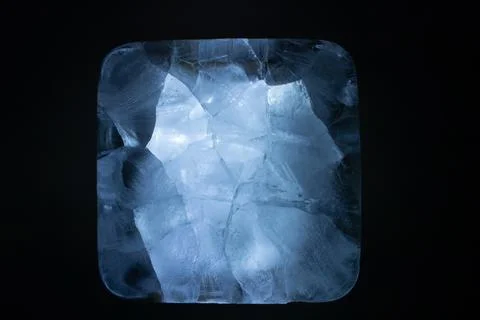 A close-up view of ice cubes in a square frame against a dark background 스톡 사진