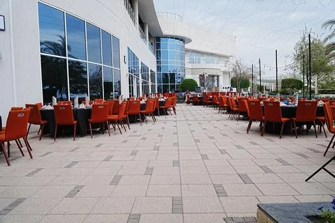Close view of iftaar setting with tables set in the row, showing round table Stock Photos