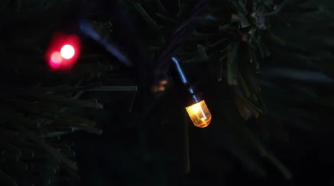 Close-up View of Illuminated Garlands Lights on Christmas Tree at Night Stock Footage 45259876