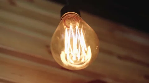 Close view of an incandescent light bulb in a cafe Stock Footage 194031075
