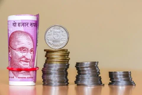 Close up view of indian rupees. Banknotes and stacked coins. Stock Photos