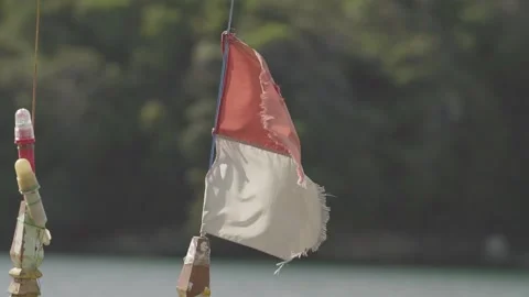 Close Up View of Indonesian Flag Waving on Wooden Boat at Sea Stock Footage 342243393
